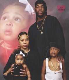 the family is posing for a photo in front of a poster