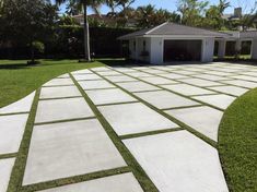 a driveway that has grass growing on the sides and walkways in front of it