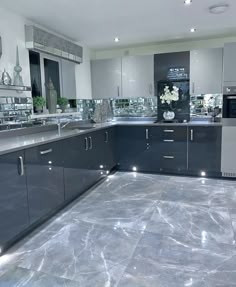 a kitchen with marble flooring and stainless steel appliances