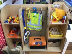 toys and construction equipment sit on shelves in a playroom