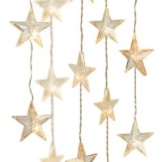 several white stars hanging from strings with lights