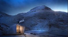 a small building sitting on top of a snow covered mountain