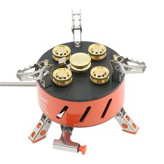 an orange and black stove with gold knobs on it's burner holder