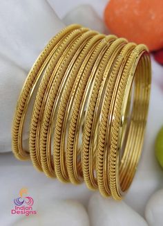 This classic set of gold-plated bangles (Set of 8), designed with a timeless rope texture that exudes both elegance and simplicity. These bangles are a perfect accessory for traditional Indian attire, making them ideal for weddings, festivals, and special occasions. Features: High-quality gold plating with a smooth finish Unique rope-textured design for added elegance Perfect for stacking or wearing individually Ideal for weddings, festivals, and everyday wear A versatile and timeless addition to your jewelry collection Care Instructions: To maintain the shine and quality of your gold-plated bangles, avoid contact with water, perfumes, and chemicals. Store them in a cool, dry place when not in use. Rope Texture, Traditional Indian Jewellery, Bangles Set, Bracelets Design, Design Bracelet, Gold Plated Bangles, Bangle Bracelet Set, Bracelets Set, Rope Design