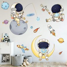 an astronaut wall decal in a child's room with space and rockets on it