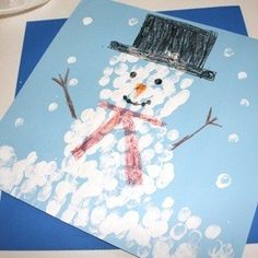 two snowmen with hats and scarfs on top of each other in front of blue envelopes