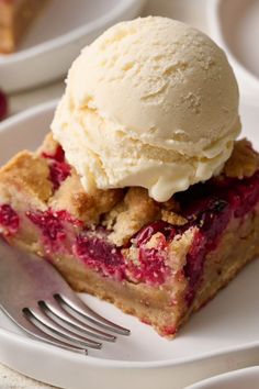 a piece of pie with ice cream on top is sitting on a plate next to a fork