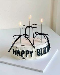 a birthday cake with candles on it sitting on a table