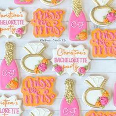 decorated cookies are arranged on a table with pink and gold decorations for bachelor's day