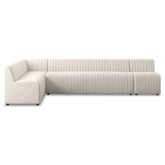 a white couch sitting on top of a white floor