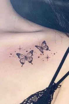 two butterflies on the back of a woman's shoulder