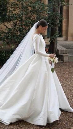 a woman in a white wedding dress and veil