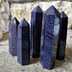 three blue crystals sitting on top of a stone slab