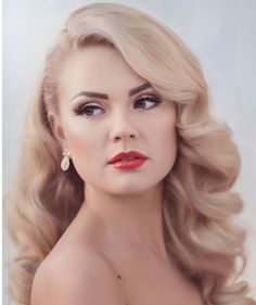 a woman with long blonde hair and red lipstick is posing for a magazine cover photo