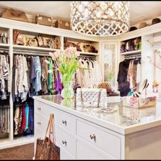 the closet is full of clothes and purses