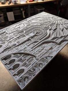 an intricately designed piece of paper is shown in the process of being cut out