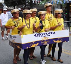 a group of people that are standing in the street with some signs on their heads