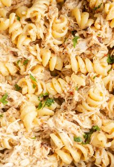 pasta with chicken and parsley in a white bowl