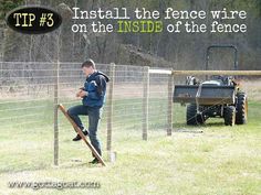 a man standing in front of a fence next to an atv