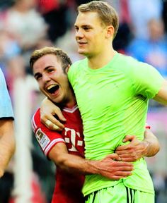 two soccer players are hugging each other on the field