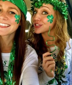 two beautiful young women wearing green hair and st patrick's day decorations