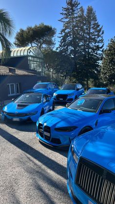 a row of blue sports cars parked next to each other