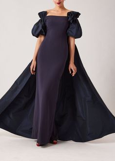 Step into timeless elegance with Teri Jon's exquisitely crafted crepe and taffeta evening gown, designed to captivate with every sway. Featuring luxurious stretch crepe fabric that skims your curves beautifully. Featuring unique puff sleeves that take this dress to another level, as well as the show stopping taffeta cape that cascades elegantly down your back. Whether you're attending a gala, black tie wedding, or special event, this gown will make you feel like the belle of the ball. Details: C Elegant Taffeta Gown For Evening, Elegant Taffeta Gown With Sweep Train, Taffeta Evening Dress With Sweep Train, Floor-length Taffeta Maxi Dress For Weddings, Evening Taffeta Maxi-length Gown, Evening Taffeta Maxi Gown, Evening Maxi Taffeta Gown, Evening Gown With Fitted Bodice In Taffeta, Evening Taffeta Gown With Fitted Bodice