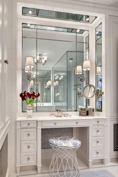 an image of a white vanity with mirrors and stools on the top shelf next to it