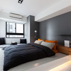 a large bed sitting under a window in a bedroom