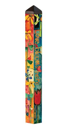 a tall wooden sign with flowers and birds painted on it's sides, in front of a white background