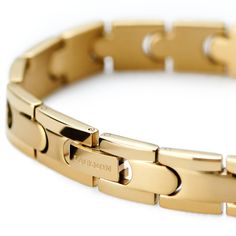 * Stunning gold-tone finish 
 * Strong and lightweight titanium Modern Gold Bracelets With Stainless Steel Clasp, Elegant Gold Magnetic Bracelets, Elegant Gold Magnetic Bracelet, Lock Bracelet, S Bracelet, Finish Strong, Titanium Bracelet, Snap Lock, Puzzle Pieces