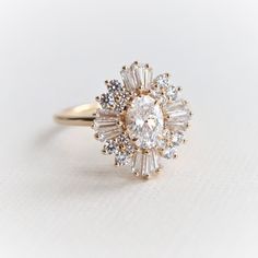 an oval diamond ring with baguetts set in yellow gold and white diamonds on the band