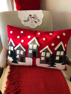 a red and white pillow sitting on top of a chair