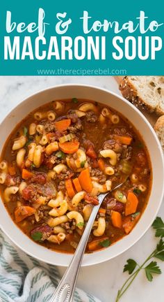 beef and tomato macaroni soup in a white bowl with bread on the side