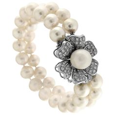 This breathtaking bracelet from the Flower Garden Collection captures elegance in every detail. It features two refined strands of luminous pearls, each complemented by a delicately crafted floral clasp adorned with 91 sparkling diamonds. The central pearl, with a 12mm diameter, adds a focal point of sophistication to this masterpiece. Gold: 18K, total weight 11 grams Diamonds: 91 stones totaling 3.03 carats, with exceptional clarity and sparkle Pearl Diameter: 12mm Stamp: 750 Exquisitely crafte Elegant Flower Bracelets For Formal Occasions, Elegant Double Strand Jubilee Bracelet, Elegant Double Strand Bracelet For Formal Occasions, Elegant Double Strand Bracelets For Formal Occasions, Elegant Formal Double Strand Bracelet, Elegant Flower Bracelets For Anniversary, Elegant Flower Bracelet For Anniversary, Elegant Double Strand Pearl Bracelet, Flower Shaped Pearl Bracelet For Wedding