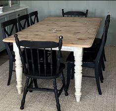 a wooden table and chairs in a room