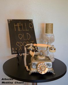 an old fashioned phone sitting on top of a table next to a sign that says hello old spot