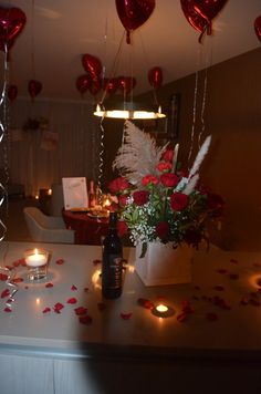 the table is decorated with red hearts and candles