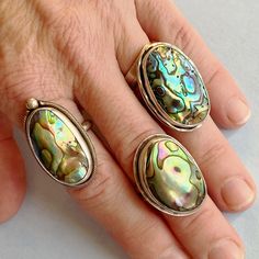 Do you love a statement ring? Abalone, also known as paua shell is sure to stand out. Abalone, also known as Paua, is the shell of a sea snail. The thick inner layer of the shell is composed of mother-of-pearl, which in many species is highly iridescent, giving rise to a range of strong, changeable colors, especially blue and green. It is truly a treasure of the ocean. In addition, each abalone shell is unique in pattern and color. I create a decorative accent with a twisted square wire around t Unique Silver Shell Rings, Unique Shell-shaped Silver Jewelry, Unique Silver Shell-shaped Jewelry, Unique Sterling Silver Shell Jewelry, Vintage Silver Jewelry With Abalone Shell, Vintage Silver Abalone Shell Jewelry, Unique Abalone Shell Jewelry, Adjustable Sterling Silver Shell-shaped Jewelry, Vintage Abalone Shell Jewelry As A Gift