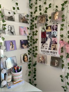 there are many pictures on the wall with ivy growing up it's sides and around them