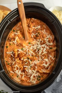 a crock pot filled with meat and cheese