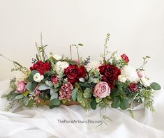 an arrangement of flowers on a white sheet