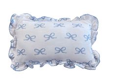 a blue and white pillow with bows on it