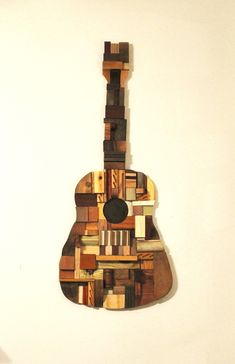 a guitar made out of wooden blocks on a wall