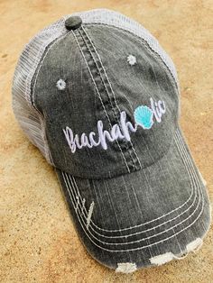 Beach hats! Embroidered, gray vintage distressed trucker hat, adjustable velkro, hole for pony. Beachaholic with teal or pink shell. Beachaholic. ~~Gray w/ pink or teal seashell. Beach please. ~~Gray w/ pink, teal or coral shell. ~~Gray w/ multicolored letters. Beach hair don't care. ~~Gray w/ pink or teal flip flops. ~~Gray w/ pink, teal, coral or yellow seashell. ~~Gray w/ pink or teal waves/anchor. ~~Black/gold letters or black/white/gold letters. Snapback. ~~Gray w/ pink, teal or coral ancho Boat Hair, Vacation Hat, Camping Hair, Seashell Beach, Resting Beach Face, Teal Coral, Boot Toppers, Beach Hats, Pink Martini