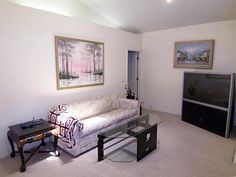 a living room filled with furniture and a flat screen tv