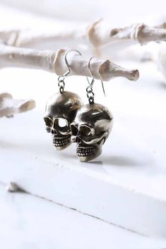 Skull earrings (XL.SIZE) . Original made and design by DEFY. - Earrings dimensions are ; approx. 1.5 x 1.8 x 2.3mm.  - Material : Brass/Silver **Free Shipping to World Wide** - Please allow us to prepare the item and parcel between 3-5 working days. For Brass / Silver plated / Gold plated (Between 5-7 working days For Sterling Silver 925) (Between 7-10 working days For Special items Sterling Silver925 with Hand painted) - All items will be sent by Thai Registered Airmail. The delivery usually takes about 2-4 weeks for parcel to arrive in most countries.   Your item will come with our gift bag Punk Style Skull Print Earrings As Gift, Skull Earrings Aesthetic, Edgy Skull Shaped Earrings For Gift, Punk Skull Print Earrings For Gift, Punk Skull Print Earrings Gift, Handmade Metal Skull Earrings, Skull Shaped Metal Earrings, Adjustable Gothic Skull Earrings, Edgy Nickel-free Skull Earrings