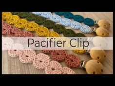 crocheted pacifier clips are lined up on a table with the words pacifier clip