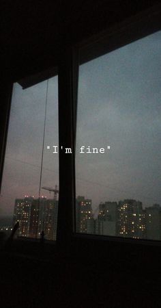 two windows with the words i'm fine written on them in front of a cityscape