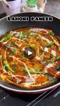 a pizza sitting in a pan on top of a stove